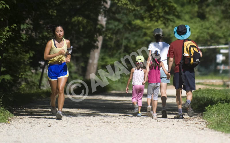 A family of day hikers and a jogger brave the heat along the Cheasapeake & Ohio Canal in the Cheasapeake & Ohio Canal National Historic Park in Great Falls, Maryland, USA, 23 July 2010. EPA/SHAWN THEW