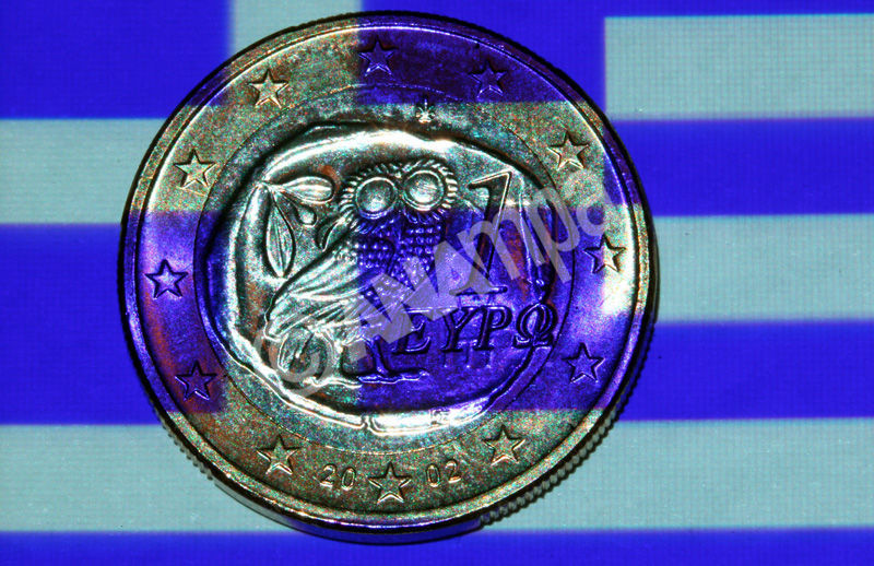 epa03316193 An illustration showing a Greek flag projected onto a Greek one euro coin in Schwerin, Schwerin, Germany, 24 July 2012. International creditors will on 24  review Greece